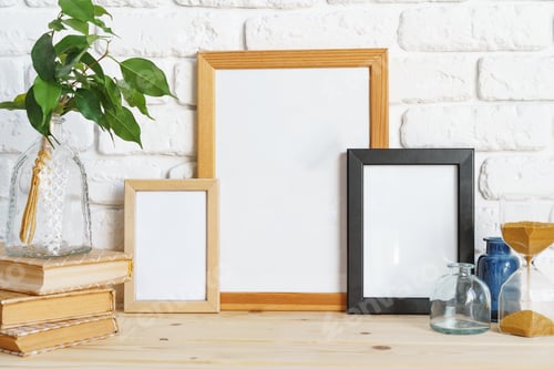 Preview: Wooden frame mockup on table with modern vase and books