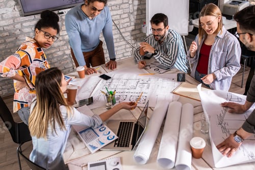 Preview: Group of modern business people in casual wear discussing architectural designs.