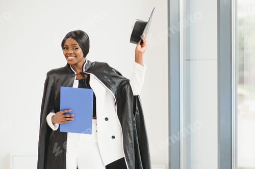 Preview: Young female african american student with diploma.