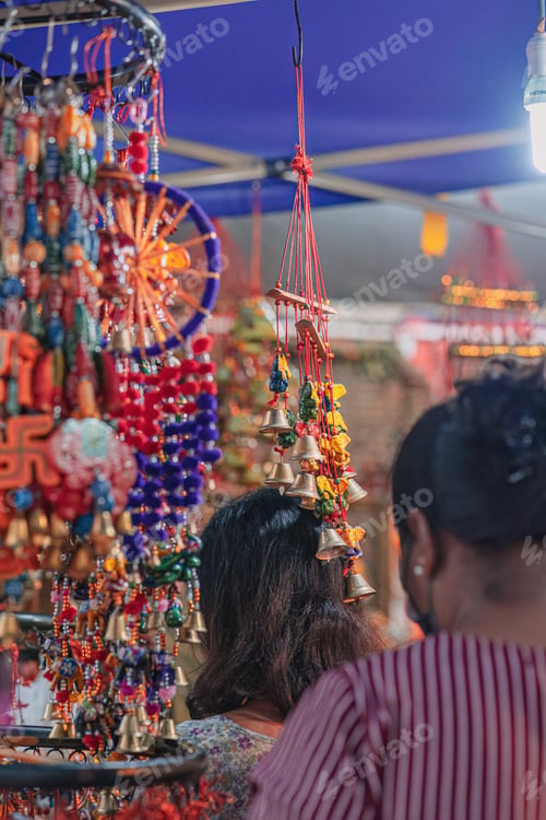 Preview: Indian handmade wind chimes with bells, decorated in colourful ornaments.
