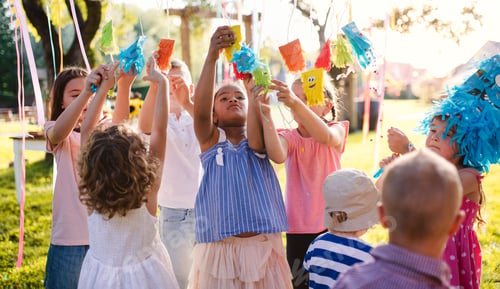 Preview: Small children standing outdoors in garden in summer, playing.