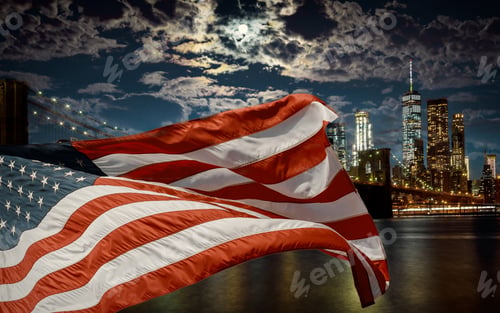 Preview: American flag flying the against a dusk sky Brooklyn Bridge and Manhattan, New York City, USA