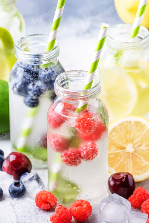 Preview: Berry and citrus fruit infused summer cold drinks in glass bottles