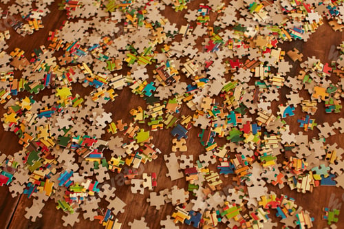 Preview: Jigsaw puzzle pieces on wooden floor