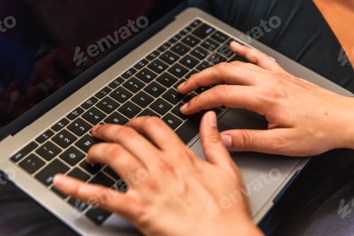 Preview: Woman typing on her laptop.