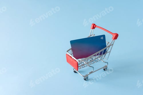 Preview: credit cart in shopping cart on blue background, online secure purchase and shopping concept