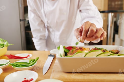 Preview: Chef garnishing baked chicken