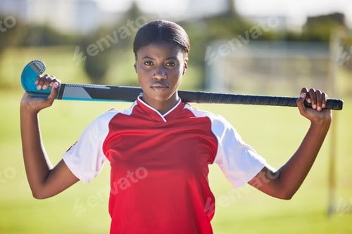 Preview: Hockey player holding stick ready for a competition or match on the sports ground or field. Portrai
