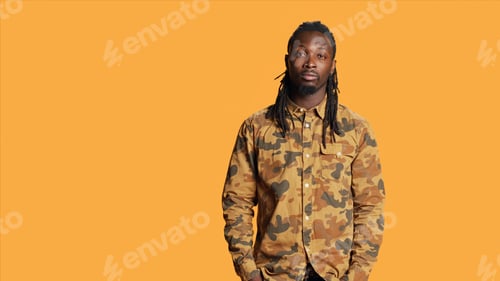 Preview: African american man with camo shirt posing in studio