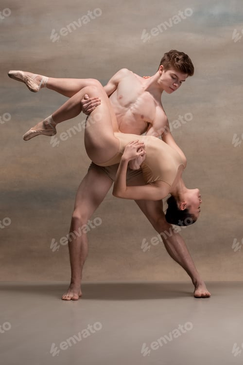 Preview: Couple of ballet dancers posing over gray background