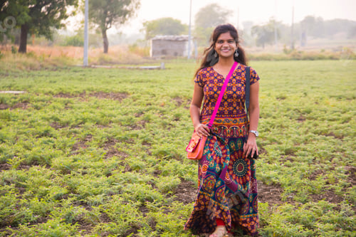 Preview: Young girl walking in chickpea field