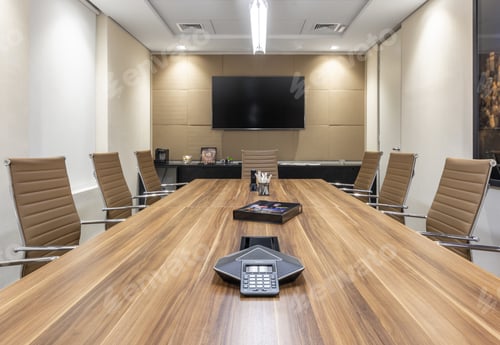 Preview: Shot of an office interior with long table, TV, comfortable chairs, projector, lighting, glass door