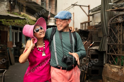 Preview: A happy senior couple strolling along a city's old neighborhood, enjoying travel
