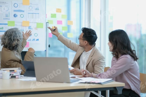 Preview: Group of Asian business people discuss together in team brainstorm meeting, work late night in