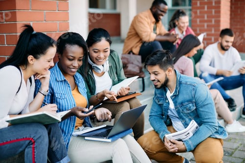 Preview: Multiracial group of university students e-learning on laptop at campus.