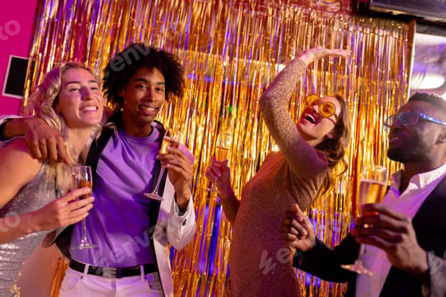 Vista previa: Two happy, diverse couples dancing and drinking champagne at a nightclub