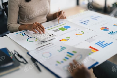 Preview: Business Professionals Analyzing Financial Data and Graphs in a Modern Office Setting