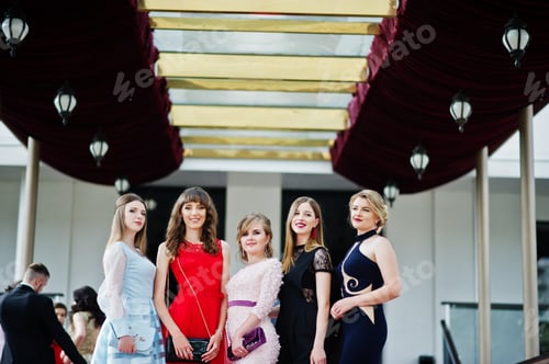 Preview: Fantastic young women in awesome fashionable dresses posing in the restaurant.