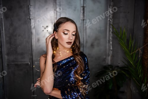 Preview: Close-up portrait of beautiful girl with an evening festive, professional make-up, garland around