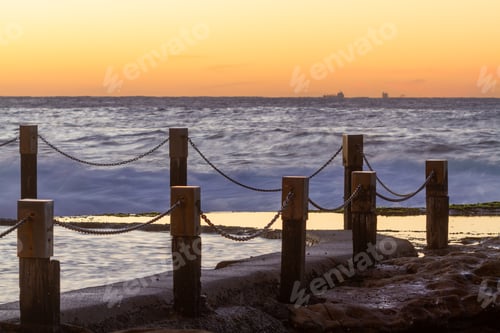 Preview: Sunrise over ocean pool at the beach