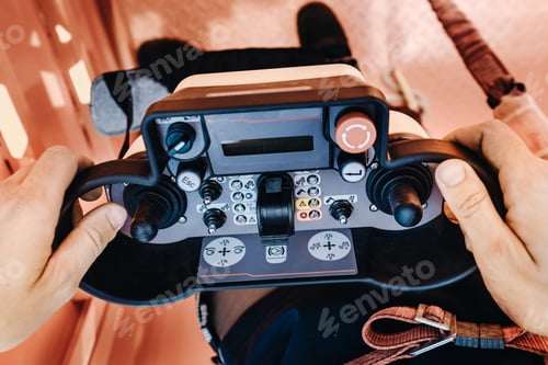 Preview: Remote control of a lifting car crane in the hands of a person. A panel with joysticks and buttons