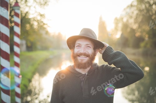 Preview: Young man wearing hat, smiling