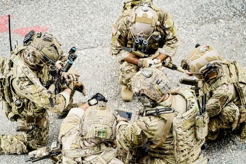 Preview: Soldier in full US MARSOC armed with assault rifle run through the abandoned building. Military