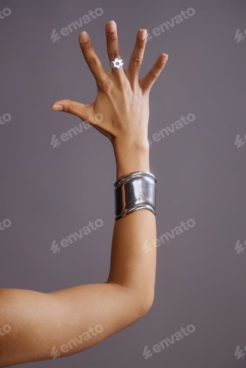 Preview: Young Woman Raising Hand Displaying Fashion Jewelry Accessory
