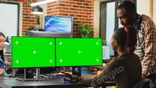 Preview: Digital company employees using greenscreen display on computers
