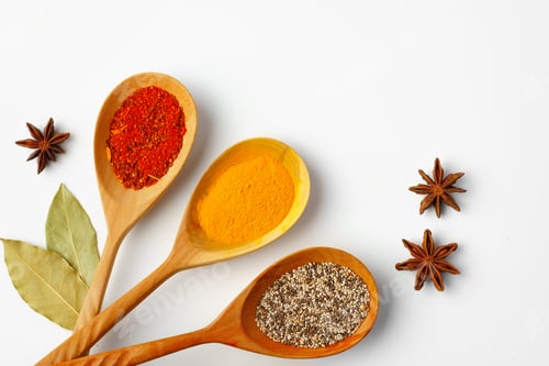 Preview: Spice in wooden spoons on white background