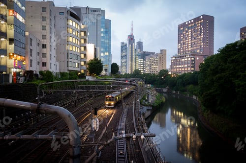 Preview: Winding train track and river running through busy Tokyo city