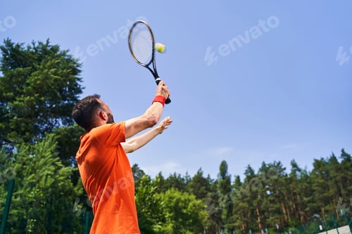 Preview: Caucasian sportsman performing an overhead tennis serve