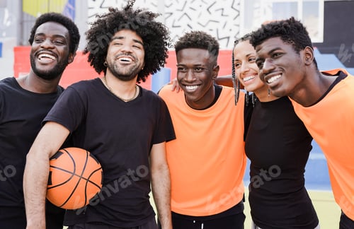 Preview: Multiethnic people hugging each other after basketball match outdoor