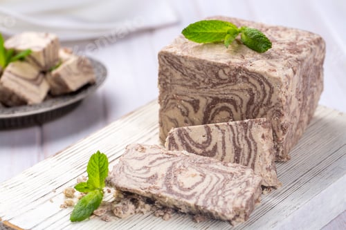 Preview: Halva dessert with sesame paste and cacao on white. Turkish name; helva