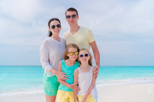 Preview: Young family on vacation on the beach. Family travel concept