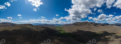 Preview: Aerial Panoramic Desert Landscape View with Mountains. Sunny Cloudy Day.