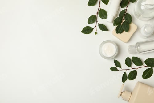 Preview: Spa cosmetic products and branches with leaves on white background, top view
