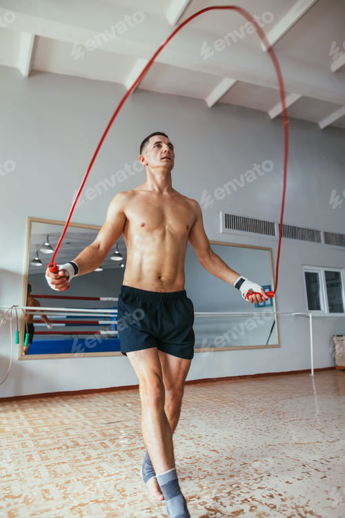 Preview: Young man skipping rope in gym