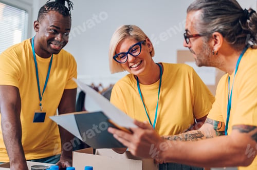 Preview: Group of multiracial volunteers working in community charity donation center