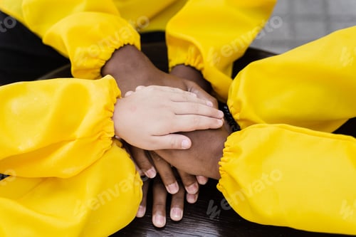 Preview: Multiracial children forming hand pile close-up, friendship activity, childhood play