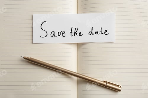 Preview: Piece of paper with phrase SAVE THE DATE on notebook, flat lay