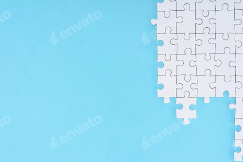 Preview: flat lay with white puzzle pieces on blue background