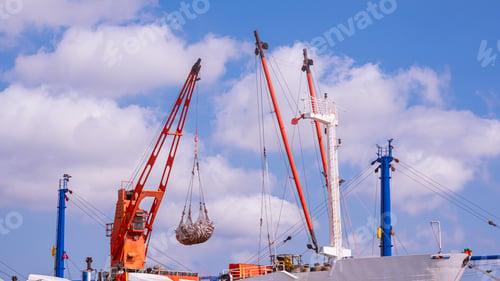 Preview: Crane on large fishing boat is transferring tuna fish into trucks at the commercial port