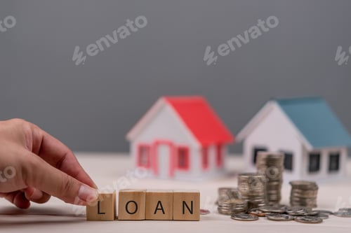 Preview: wooden blocks spelling LOAN beside house models, symbolizing home loans and real estate