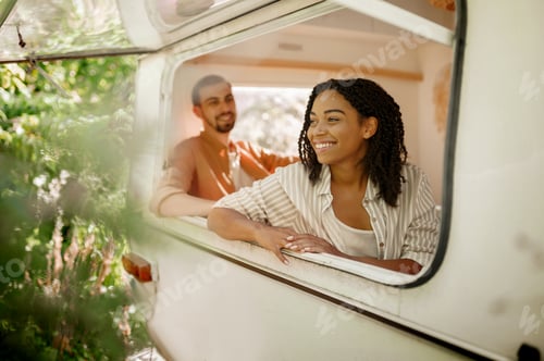 Preview: Husband and wife looks out of rv window, trailer