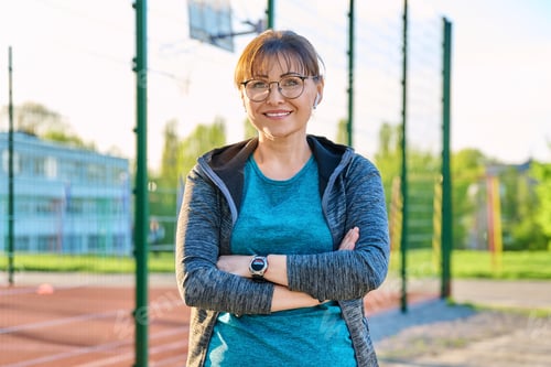 Preview: Outdoor portrait of active smiling middle aged woman looking at camera