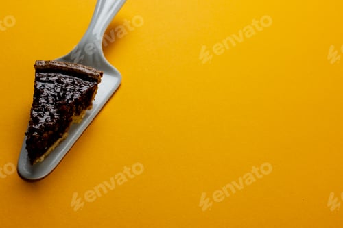 Preview: Composition of piece of pie on pie server on orange background