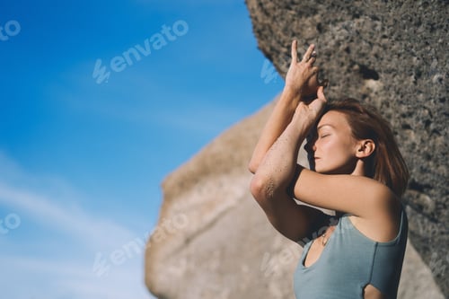 Preview: Woman doing yoga practice and meditating on the beach