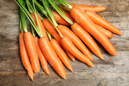 Preview: Ripe carrots on wooden background, top view