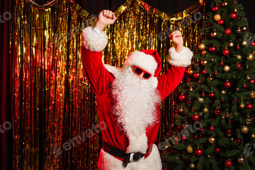 Preview: Father christmas in sunglasses dancing during party near pine tree and tinsel